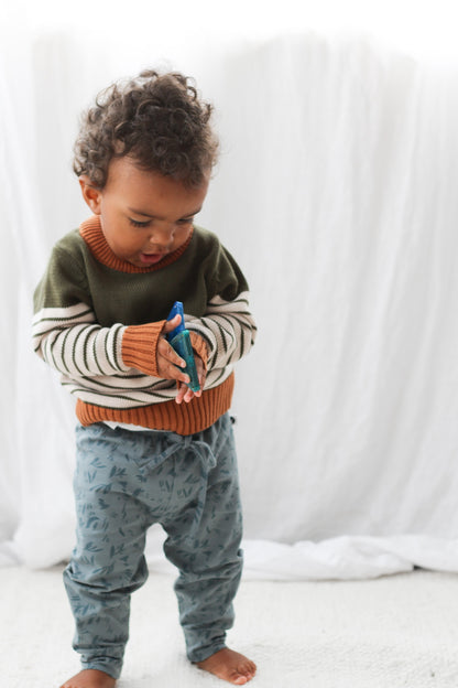 Boy wearing Burrow and Be Marks baby pants and long sleeve sweater