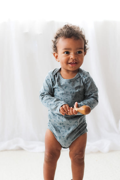 Toddler wearing Burrow and Be Marks Long Sleeve Bodysuit_2 with musical instrument