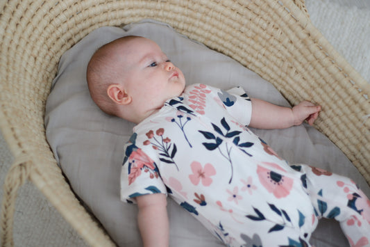 Baby in Moses basket wearing Burrow and Be Pink Clementine Zip Suit - Short Sleeve_1