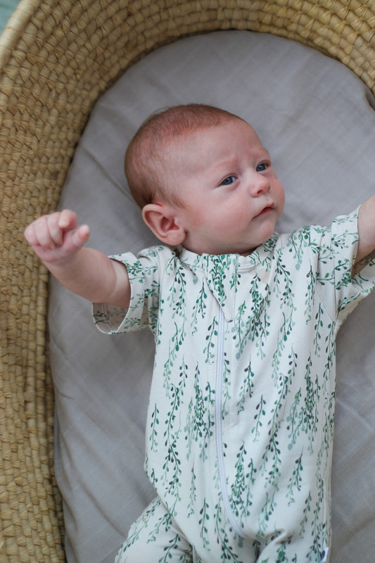 Baby in Moses basket wearing Burrow and Be String of Pearls Zip Suit - Short Sleeve