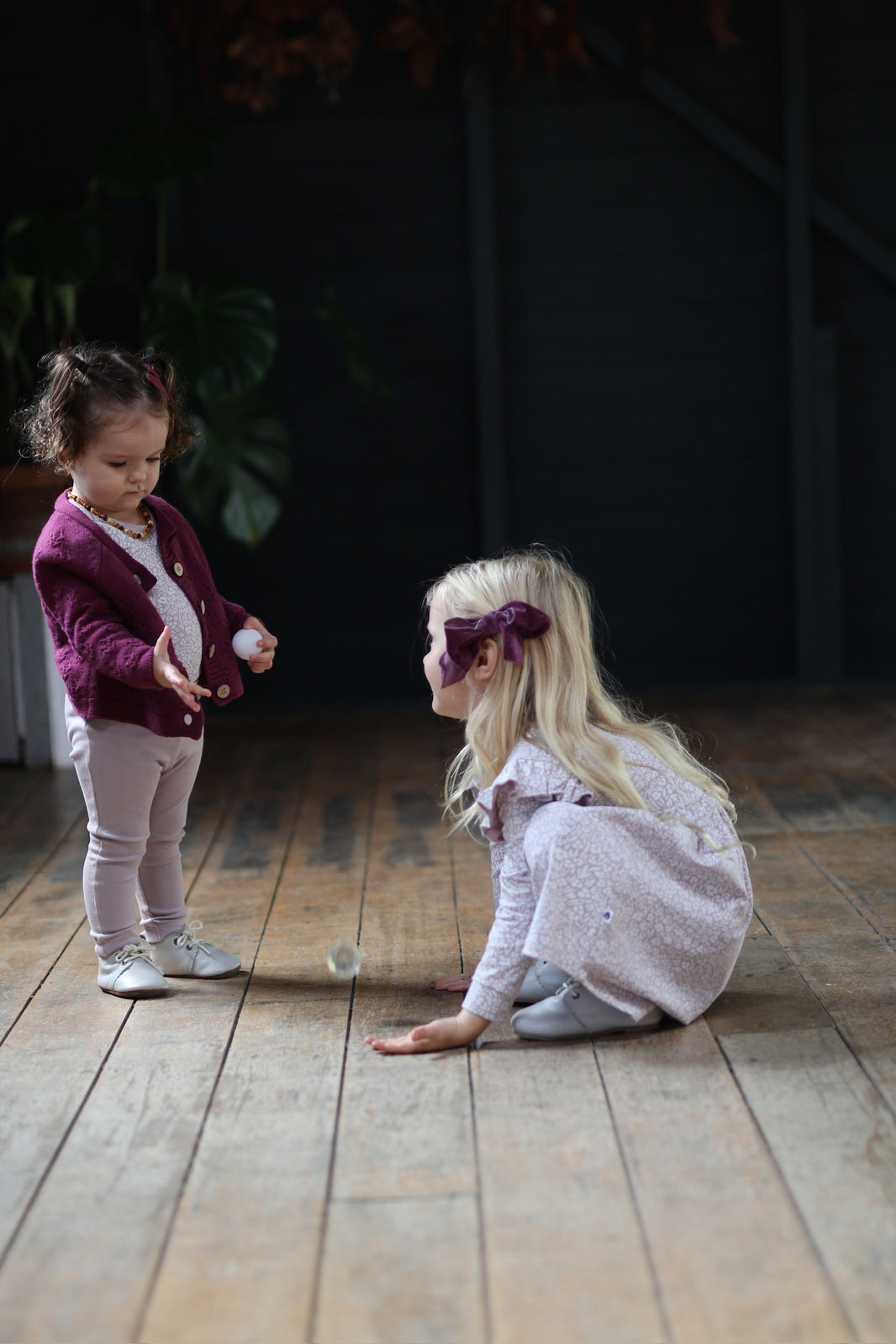 Baby girl wearing Addison Knit Cardigan, Wildflower Bodysuit and Essential Derby Rib Leggings - Lavender, and Girl wearing Wildflower long sleeve flutter dress, all designed by Burrow and Be