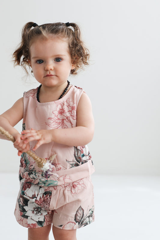 Baby girl posing at camera while wearing Tropical Bouquet Singlet - Fleur and Tropical Bouquet Lyla Shorts - Fleur, both designed by Burrow and Be