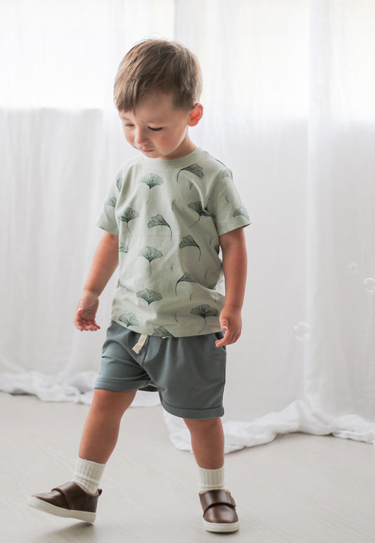 Toddler wearing Sage Baby Shorts and Ginkgo Classic T-Shirt from Burrow and Be